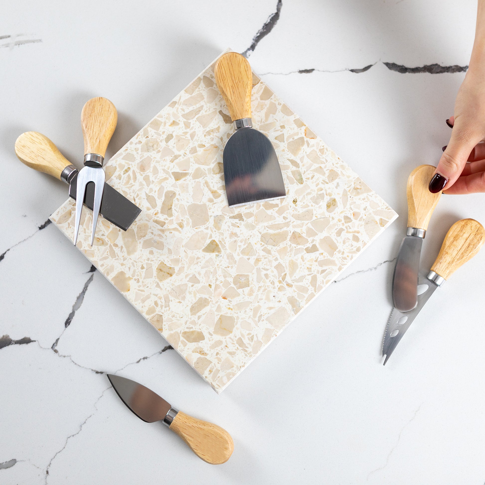 Insieme Homewares Medium Antipasti Cheese Knife Set in Estate — soft, neutral-toned terrazzo platter accompanied by six cheese knives, ideal for elegant entertaining and sharing bites at relaxed gatherings.