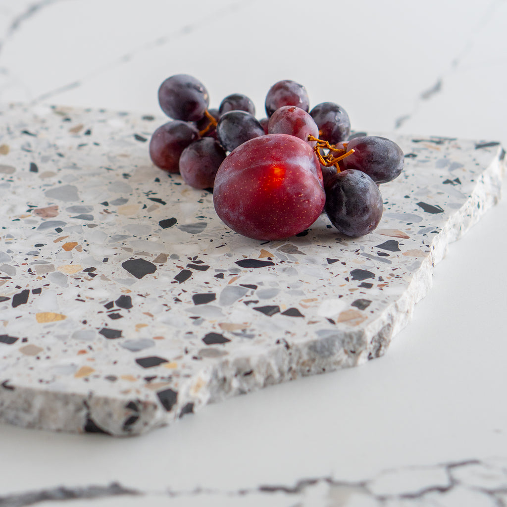Detail shot of an Autunno organic terrazzo platter styled with fruit.