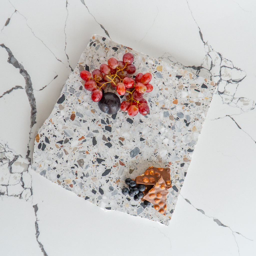 Autunno organic terrazzo platter styled with chocolate and fruit.