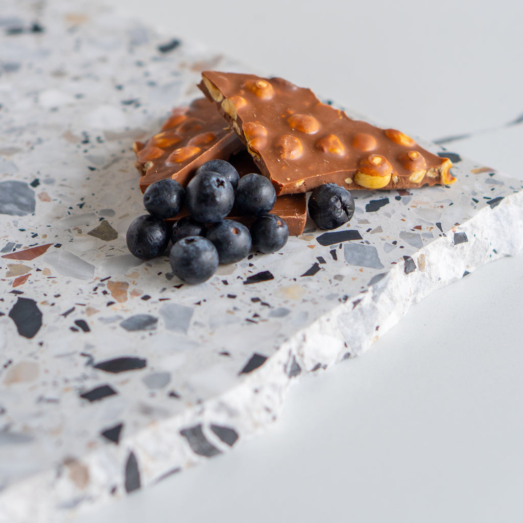 Autunno organic terrazzo platter styled with chocolate and fruit.