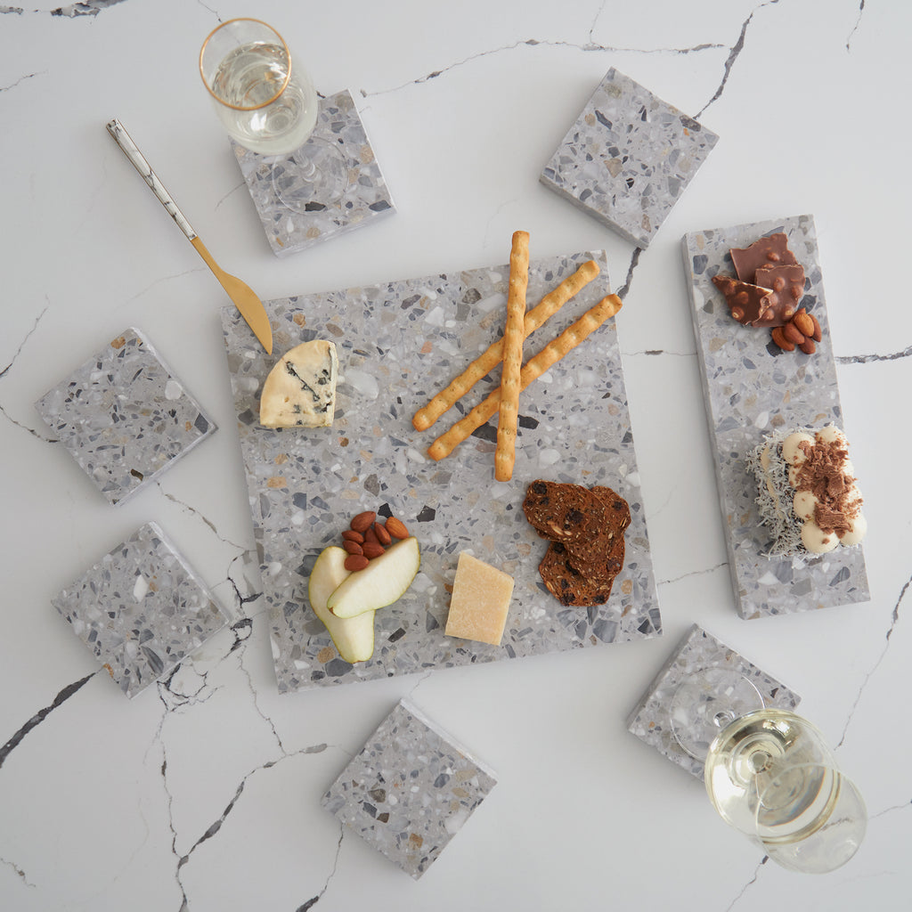 Primavera Tasting Set styled with condiments and garnishes, featuring a soft stone blend ideal for brunch or gifting.